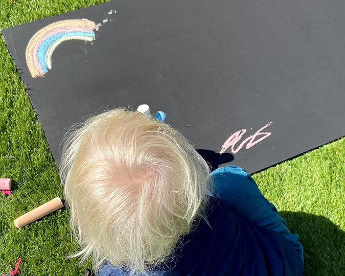 Child using blackboard made with Viponds Chalkboard Paint