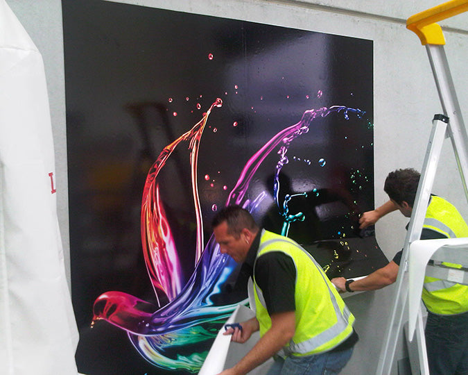 Men applying digital image to a wall prepared with Viponds Self Adhesive Prep Coat